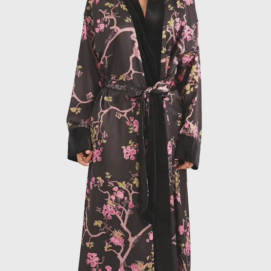 Marisol wearing the Queens Wear Robes Midnight Blossom robe in black and pink in a product video.