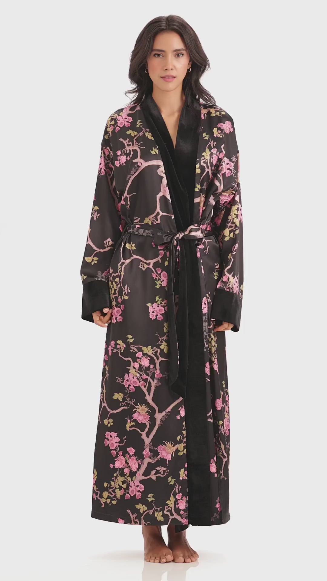 Marisol wearing the Queens Wear Robes Midnight Blossom robe in black and pink in a product video.